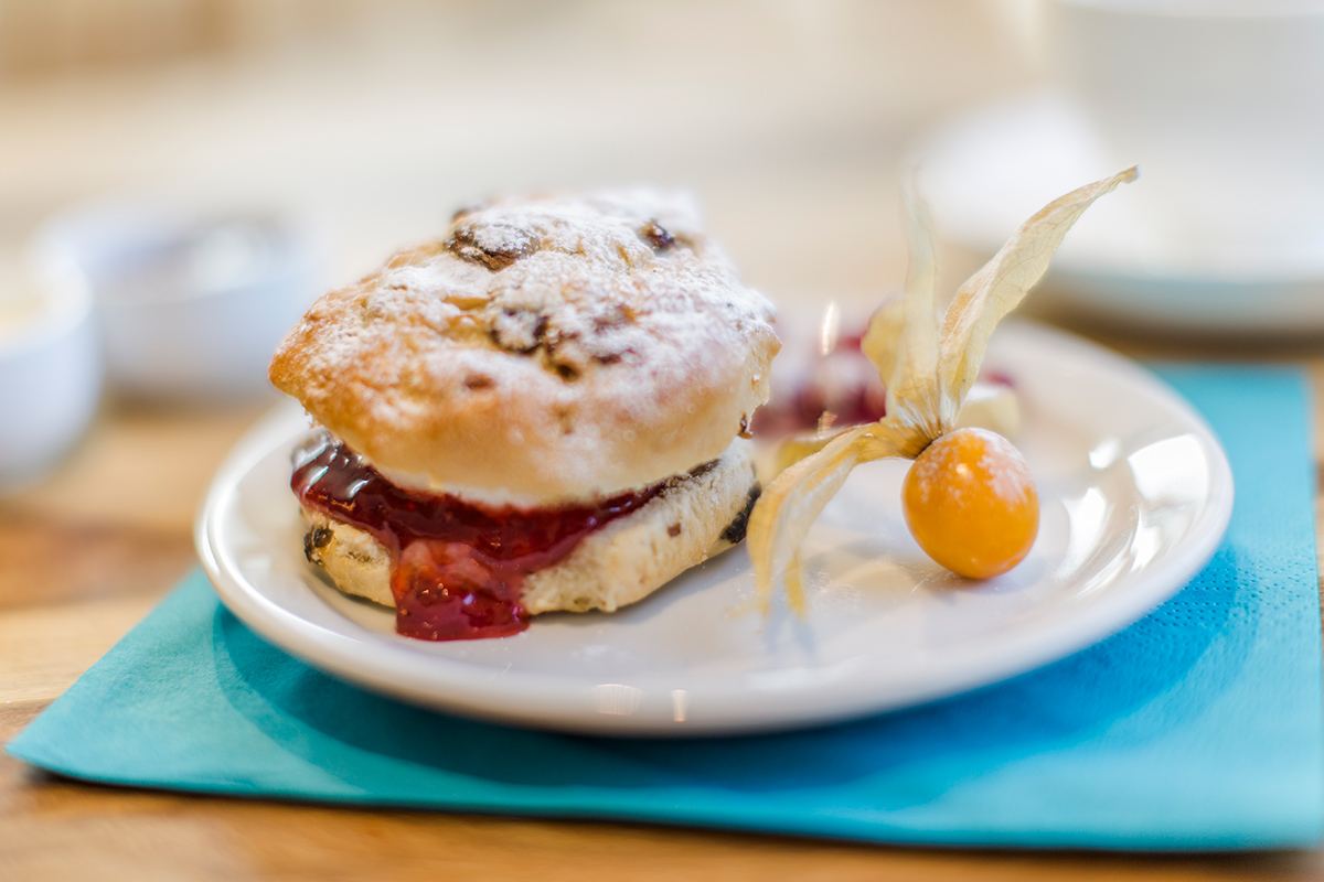 A scone with jam and cream